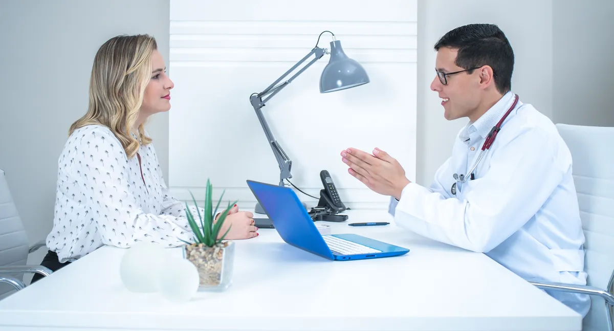 Woman discussing weight management options with her doctor